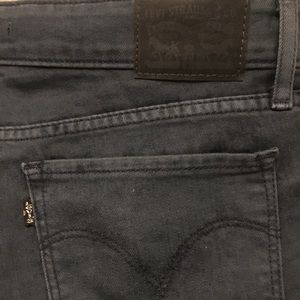 Distressed dark wash Levi skinny jeans